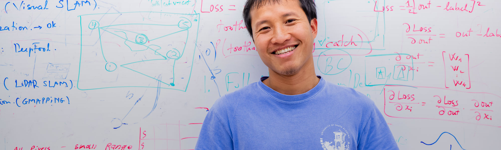 grad student in front of white board
