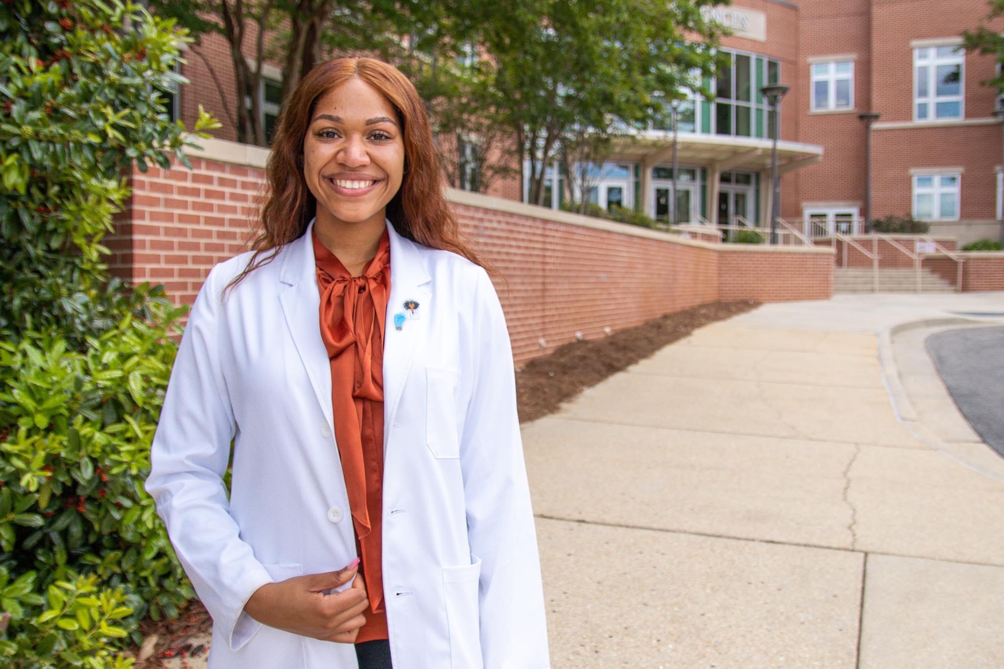 Image of Physician Assistant Studies student looking in another student's ear.