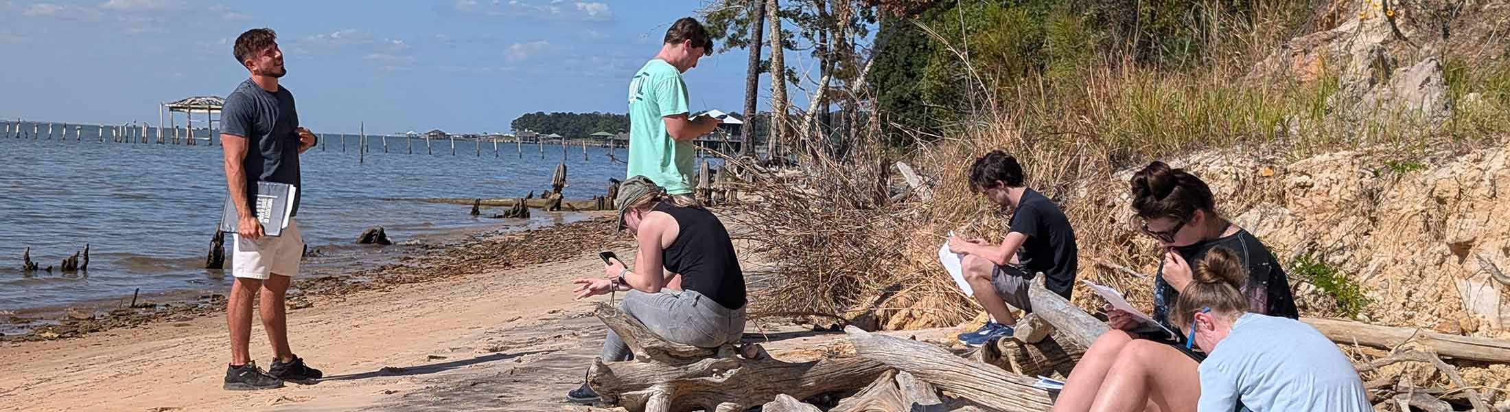 Students working with samples on the beach.