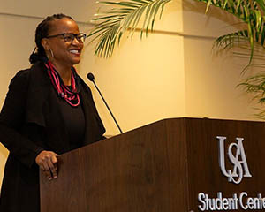 Female speaking at the Student Center on the Stokes Center for Creative Writing.