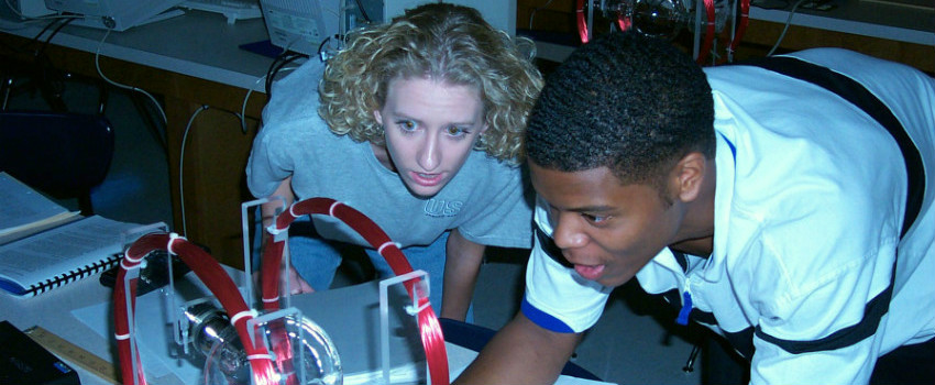 Two students working in physics lab.