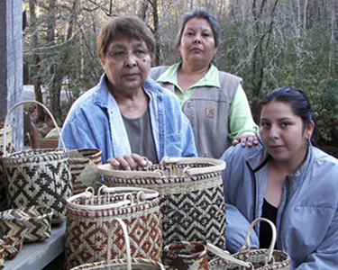 Native Americans with woven baskets.