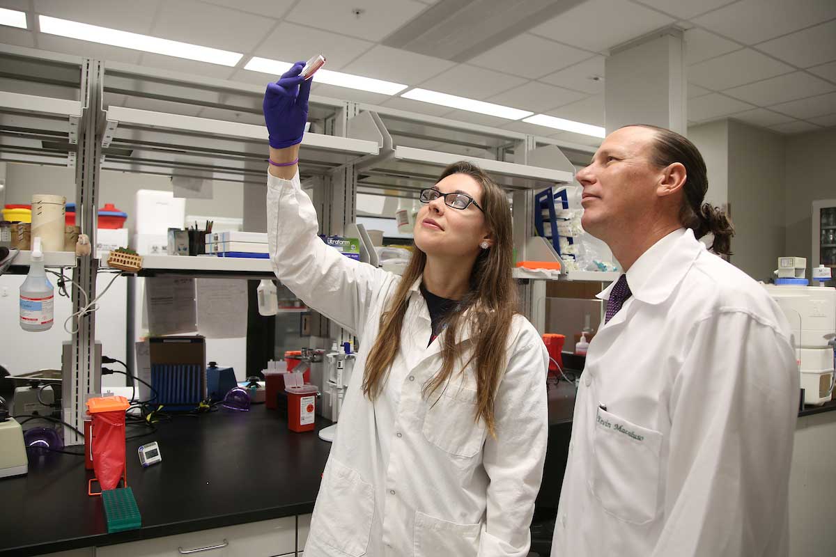 Hanna Laukaitis, a graduate researcher, and Kevin Macaluso, Ph.D., professor and chair of microbiology and immunology, work in the Laboratory of Infectious Diseases in this file photo.