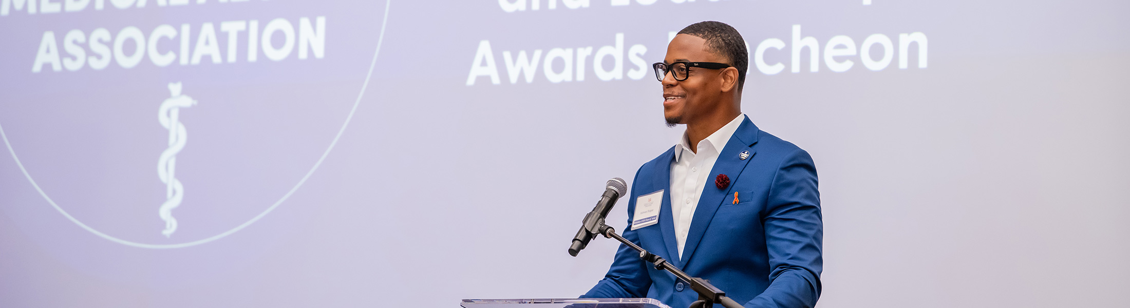 Man speaking at awards ceremony.