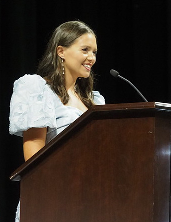 Female student speaks at podium