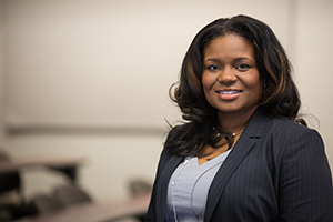 Female smiling in classroom at one of the top business schools in alabama.