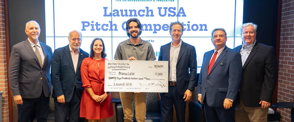 Student receiving check at Launch USA Competition.