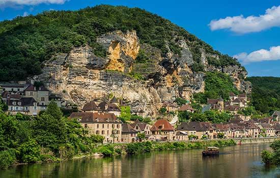 Mountain with houses in front of it and lake in Northern Italy.