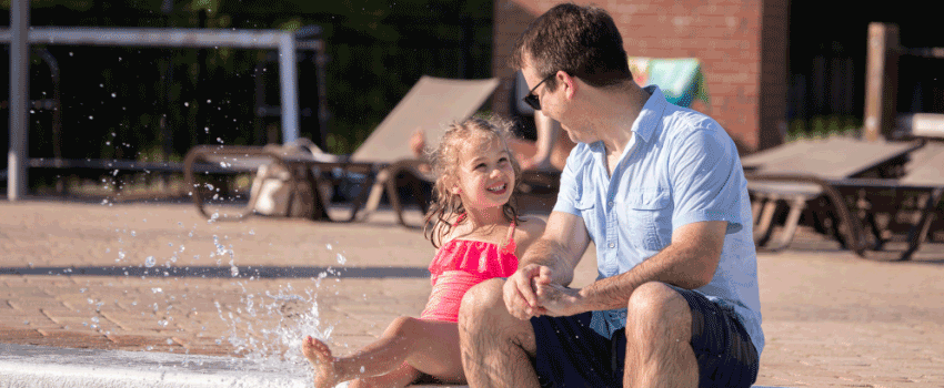Jeb Shrenk looking at his little girl splashing in rec center pool