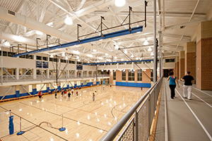 Student playing basketball in the rec center.