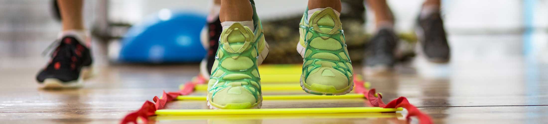 Tennis shoes running through a fitness ladder