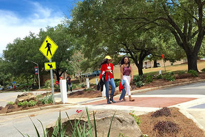 Students walking across crosswalk.