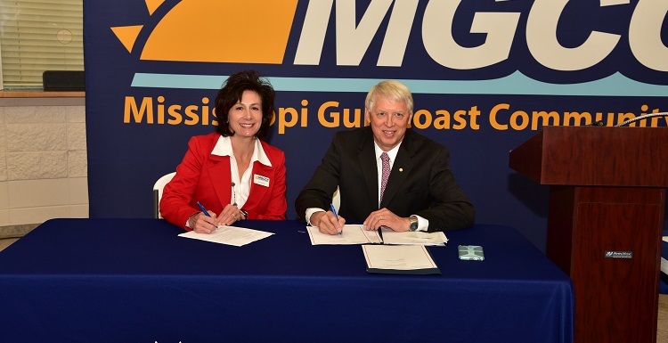 Dr. Mary Graham, Mississippi Gulf Coast Community College president, left, and Dr. Tony Waldrop, USA president, sign a commitment for the Pathway USA program. data-lightbox='featured'