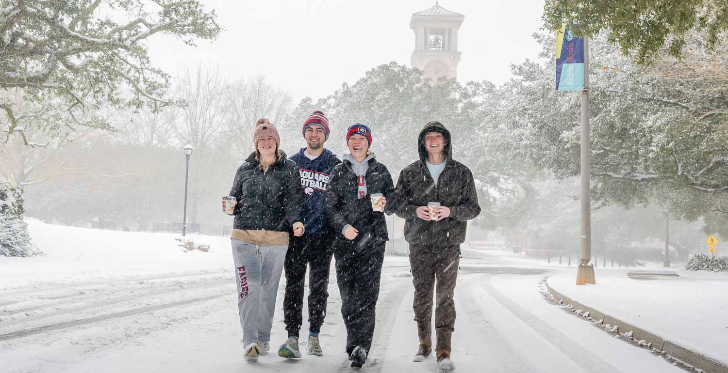 Students walking in the snow on campus. 