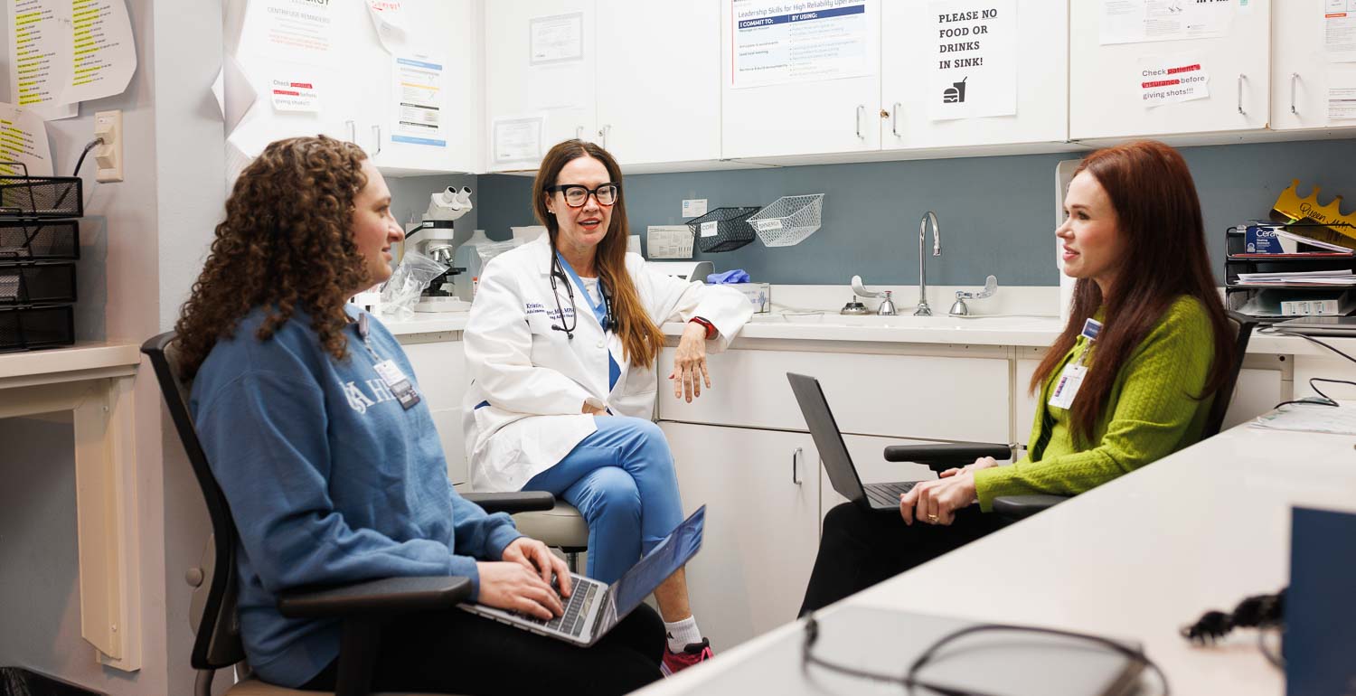 University of South Alabama doctoral students Victoria Chassin, left, and Rachel Henderson, right, discuss patient care with Dr. Kristin Rager, professor and division chief for adolescent medicine at USA Health, at the Adolescent and Young Adult Health clinic on Old Shell Road.